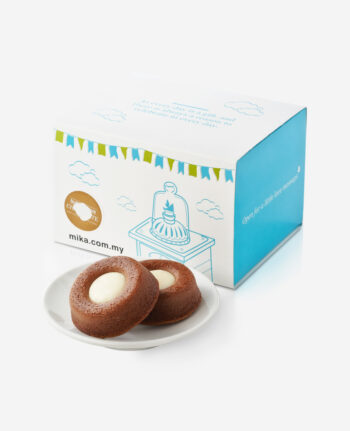Two chocolate ring cookies with white centers on a white plate beside a pastel blue and white gift box with cloud illustrations.